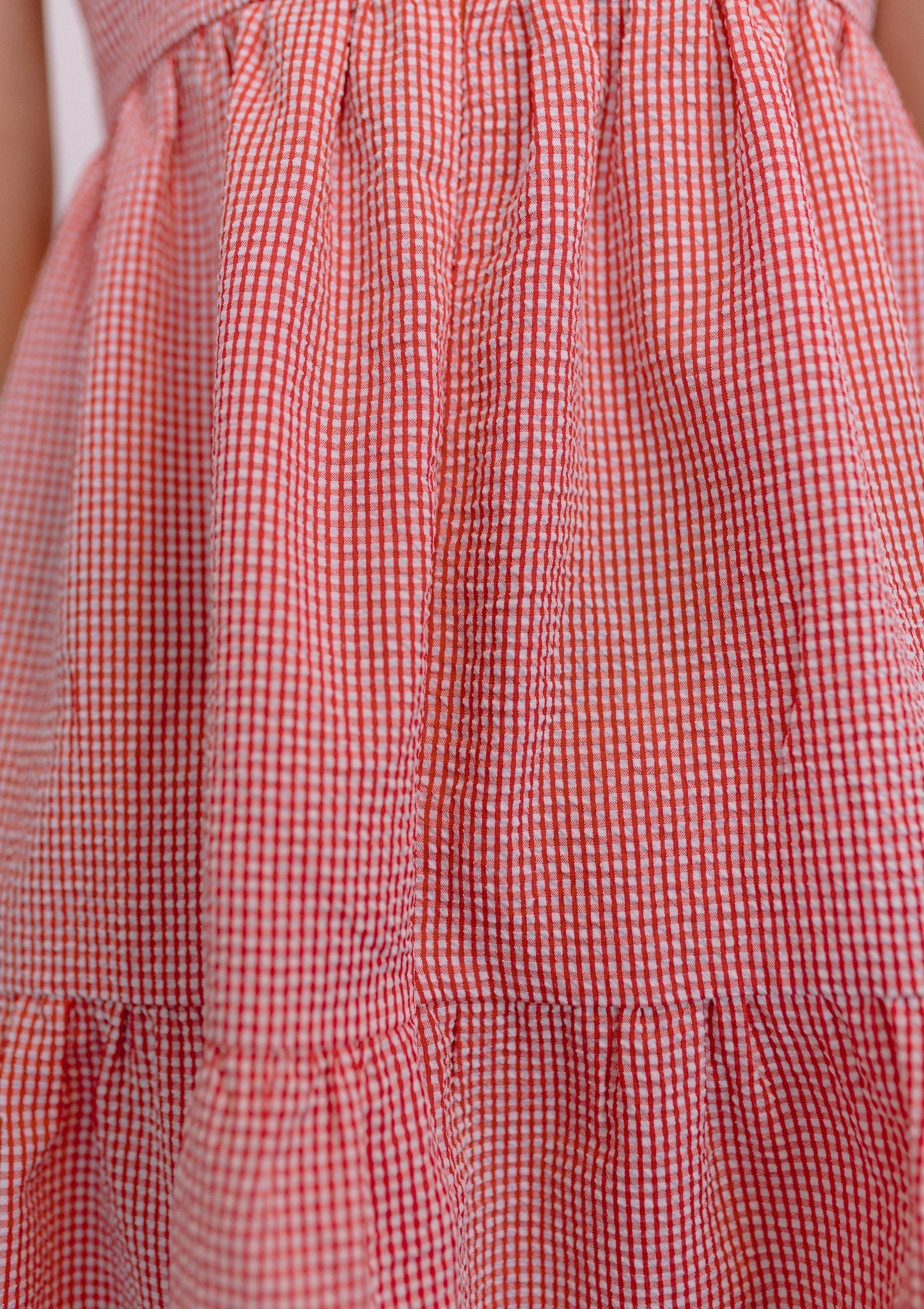 Ethical and sustainable clothing made in Canada - Pros and Cons Apparel.  Tie up gingham mini dress; tiered gathered skirt, Above knee sundress