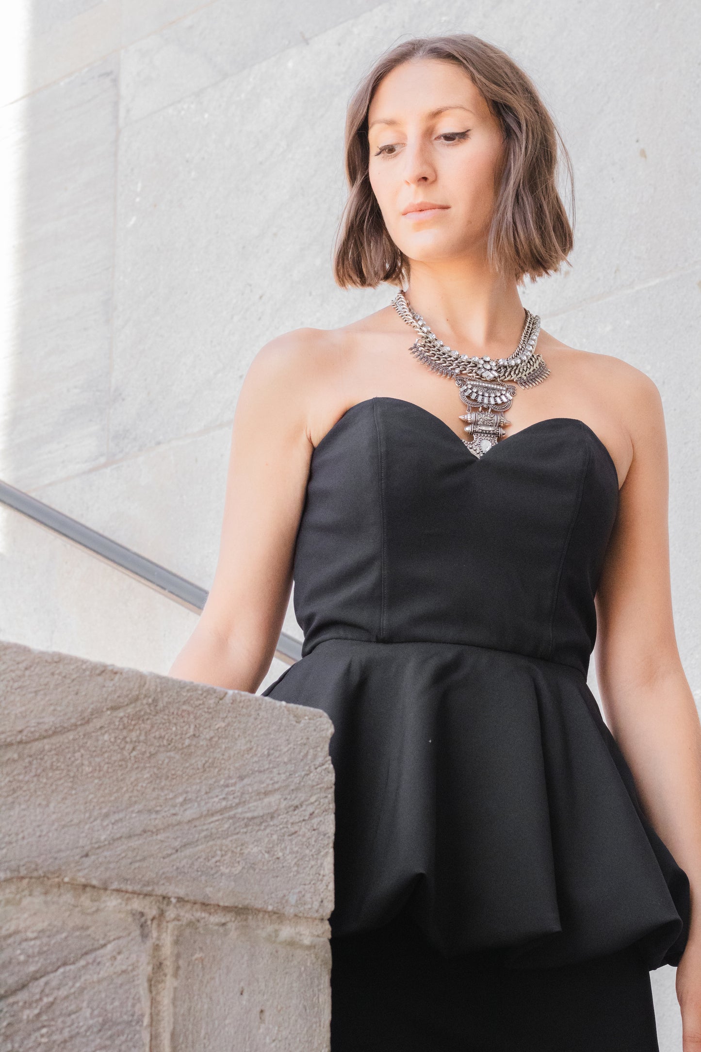 Ethical and sustainable clothing made in Canada - Pros and Cons Apparel.  Strapless little black dress - sweetheart neckline sleeveless mini dress - peplum skirt LBD